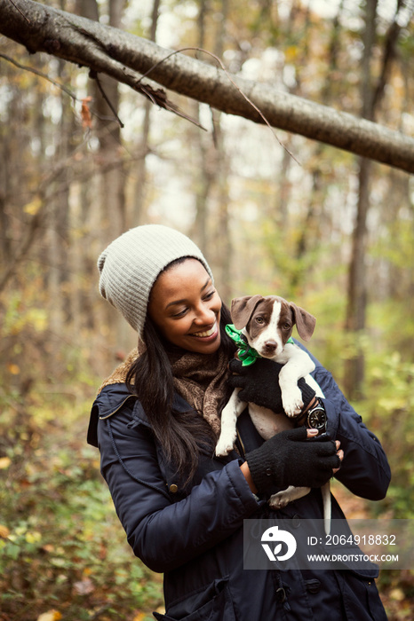 Portrait of young woman with her puppy