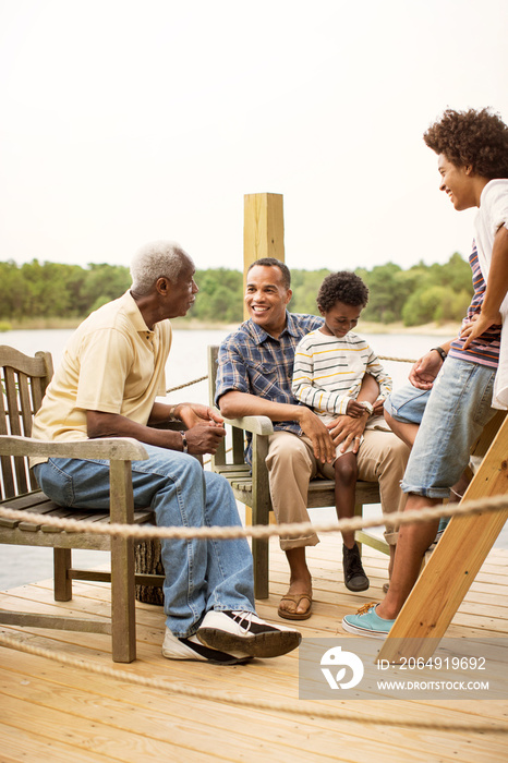 Boy (6-7) sitting with family on pier