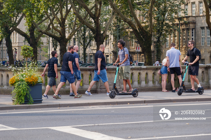 People use and ride E-scooter on the bicycle lanes and pedestrian walkway at Königsallee in Düsseldo