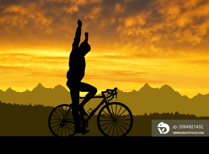 Silhouette of the cyclist riding a road bike at sunset