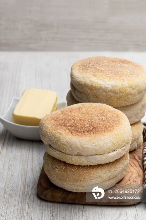 Freshly baked English muffins on white wooden table