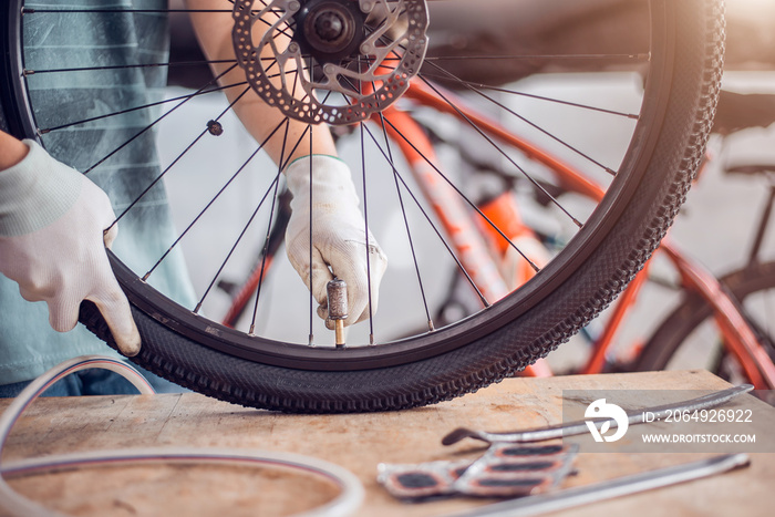 Bicycle Tire Care, Cyclist are fixing bicycle wheels, Close-up.