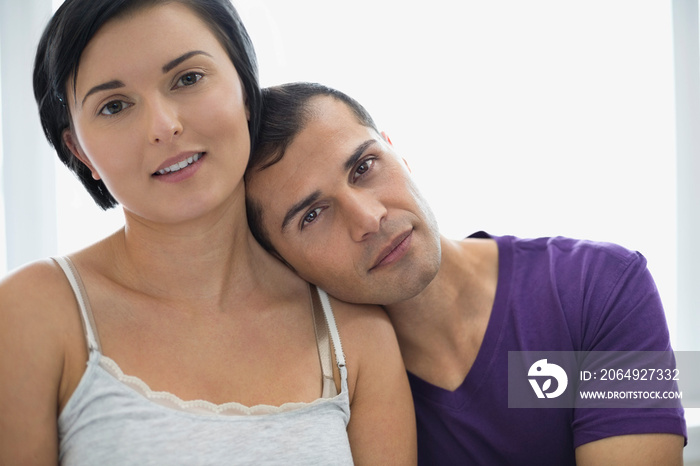 Portrait of man resting head on wifes shoulder