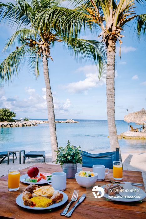 breakfast on a table by the beach looking out over the ocean, Caribbean sea with breakfast table wit