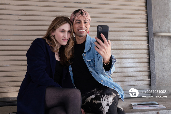 Lgbtqia friends sitting and posing together.