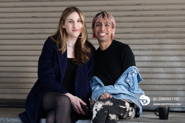 Lgbtqia friends sitting and posing together.