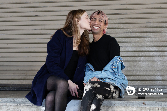 Lgbtqia friends sitting and posing together.