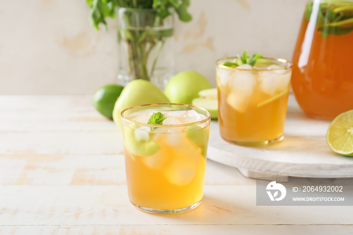 Glasses of tasty ice tea on wooden background