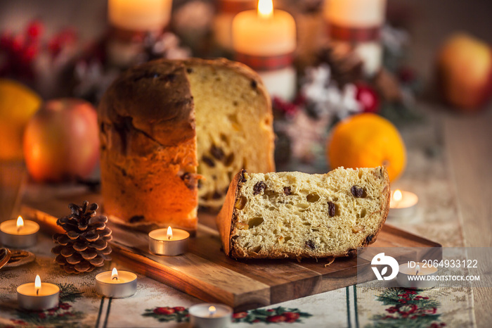 Delicious panettone on christmas table wit decorations and advent wreath and candles