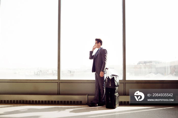 Businessman talking on phone in railroad station