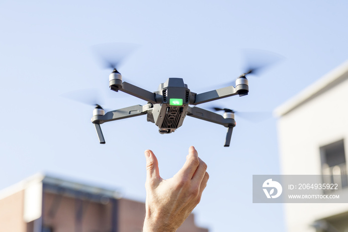 black drone lands in the hands of technician