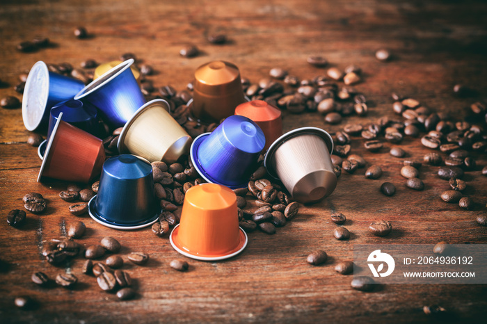 Colorful espresso capsules on wooden background