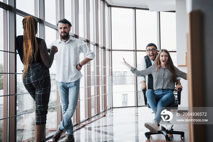 A group of business people having fun, at the office. Celebrate a successful contract.