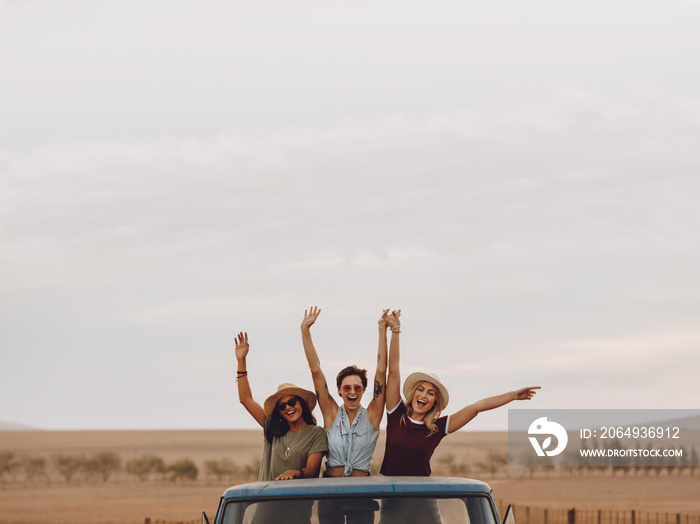 Friends having fun in the open back of a truck