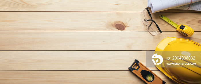 Work safety. Standard Construction site protective equipment on  top view wooden background, flat la