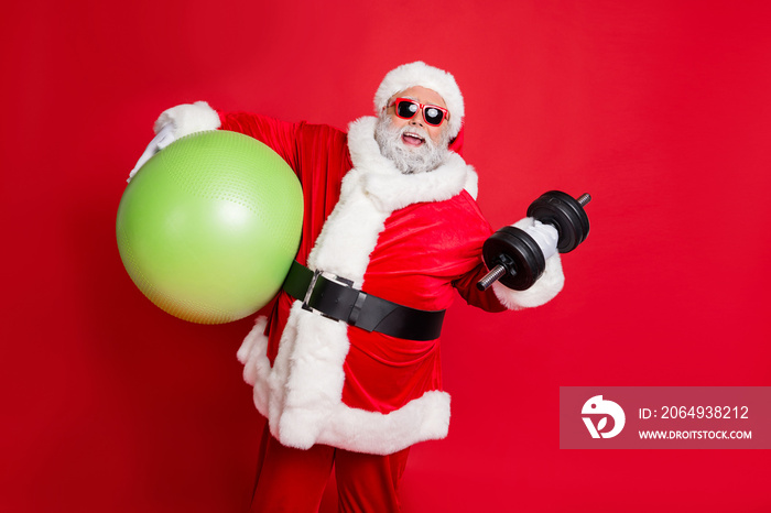 Portrait of excited christmas father in eyewear eyeglasses practice fitness with dumbbells fitball i