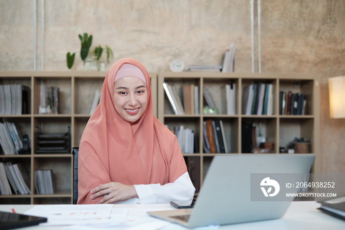 Portrait of beautiful startup business founder who Islamic female person with hijab, smiling and loo