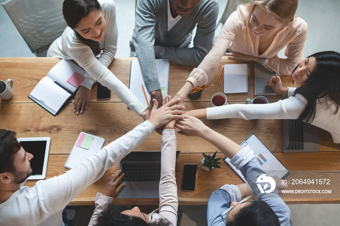 People putting hands together for united, cooperation and teamwork concept