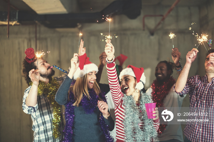 multiethnic group of casual business people dancing with sparklers