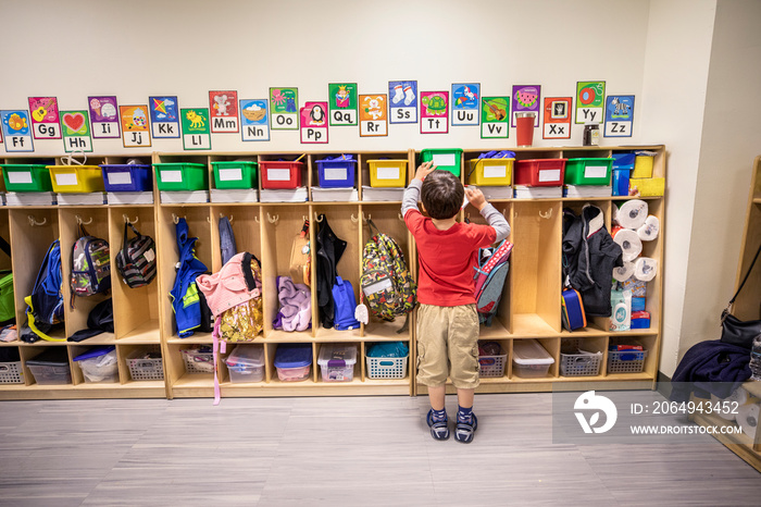 Boy putting away book