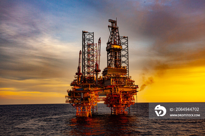 oil drilling rig at sunset