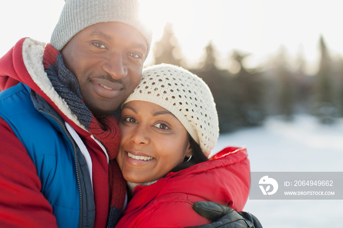 Portrait of romantic couple embracing outdoors in winter