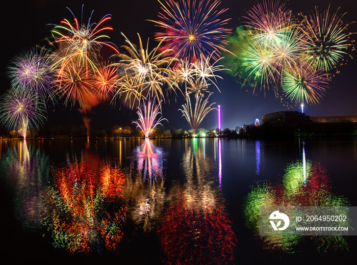 Multiple fireworks over lake Dutzendteich at spring fair in Nuremberg