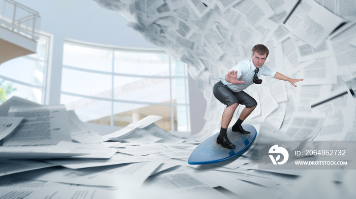 Businessman rides a surfboard on piles of papers