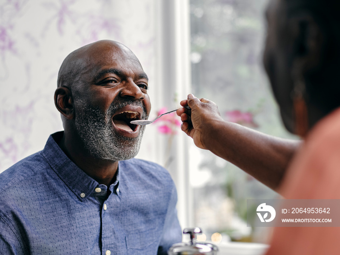 UK,ÊClose-upÊof woman feeding man at hotel table