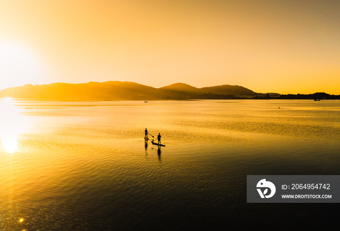 Practicing stand up pandle at sunrise at Lagoa da Conceição in Florianópolis Santa Catarina Brazil