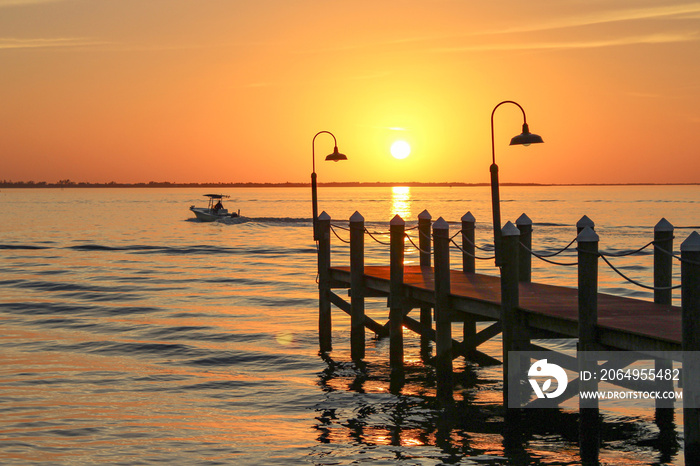 Boat leaving at Punta Rassa pier in Florida for Sanibel Island during sunset