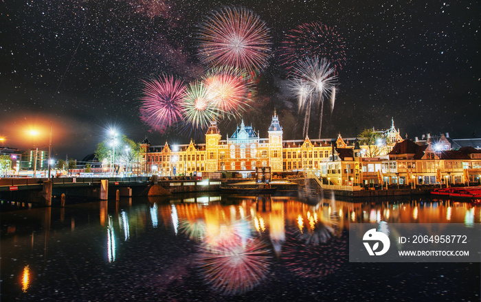Beautiful calm night view of Amsterdam city. Colorful fireworks on the black sky background. Photo g