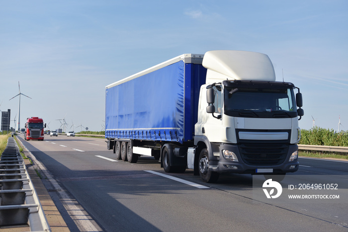 trucks on the road transporting goods in trade  // LKW beim Warentransport im Fernverkehr auf der St