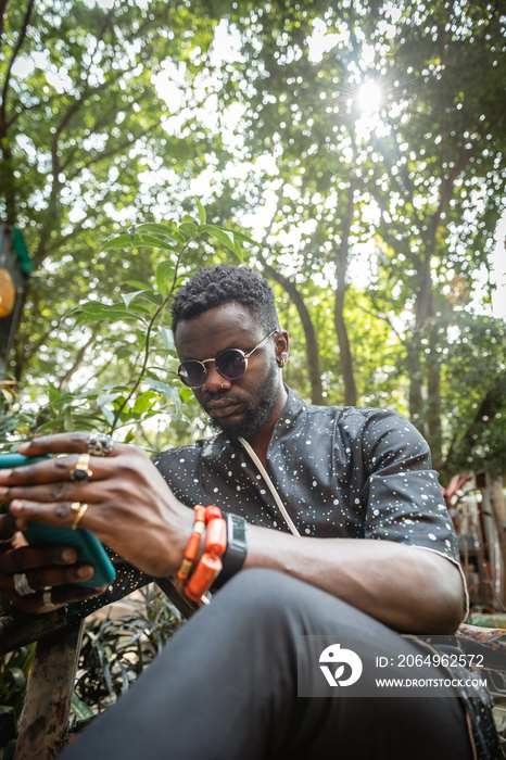 man on his phone in a garden