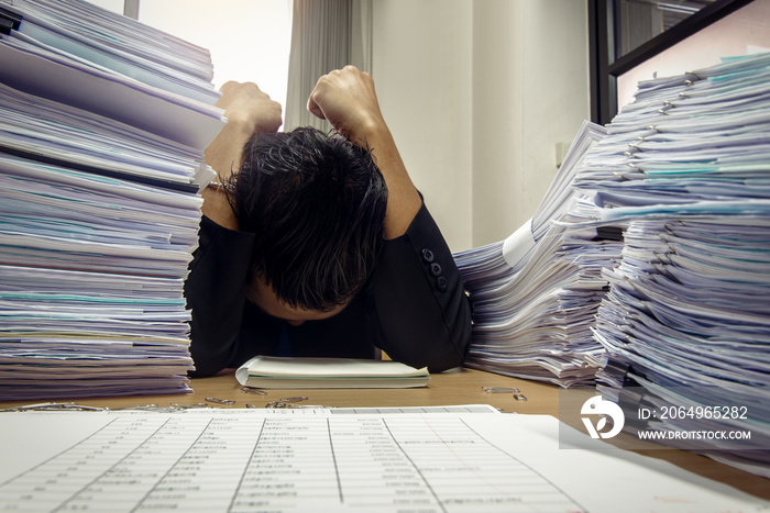 documents on desk stack up high waiting to be managed