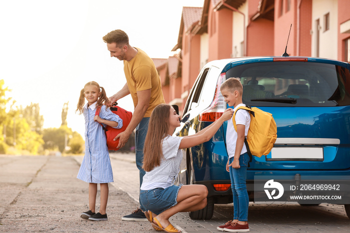 Parents saying goodbye to their children near school