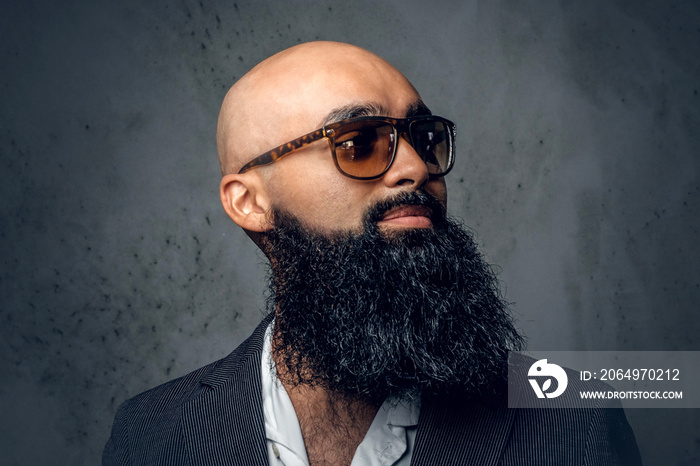 Arabic bearded shaved head male in sunglasses.