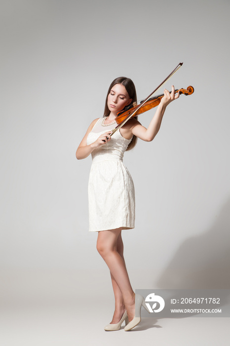 Beautiful young woman playing violing