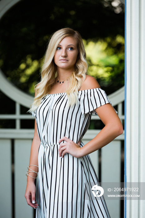 High School Senior Photo of Blonde Caucasian Girl Outdoors in Romper Dress