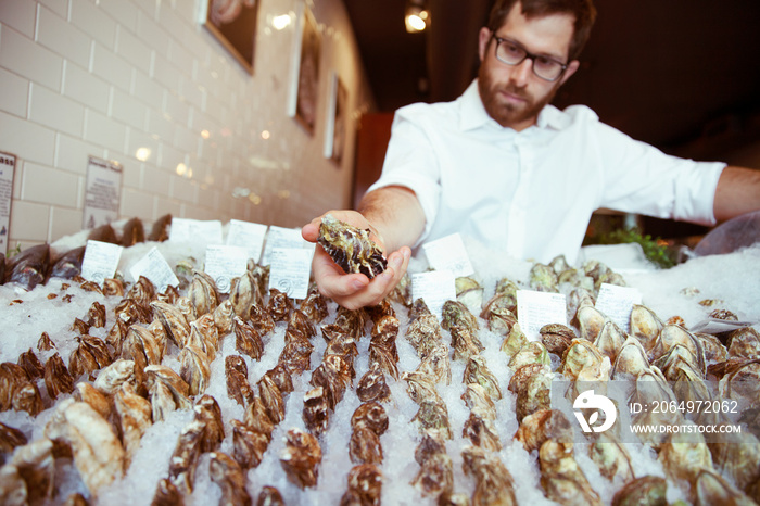 Fish vendor holding mussels