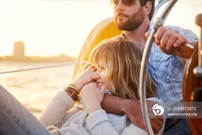 Couple sailing woman looking away