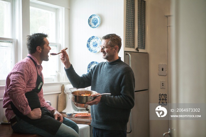 Mature men sharing meal