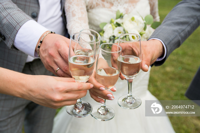 wedding bouquet of flowers in the hands of the bride.glasses with champagne in hand.