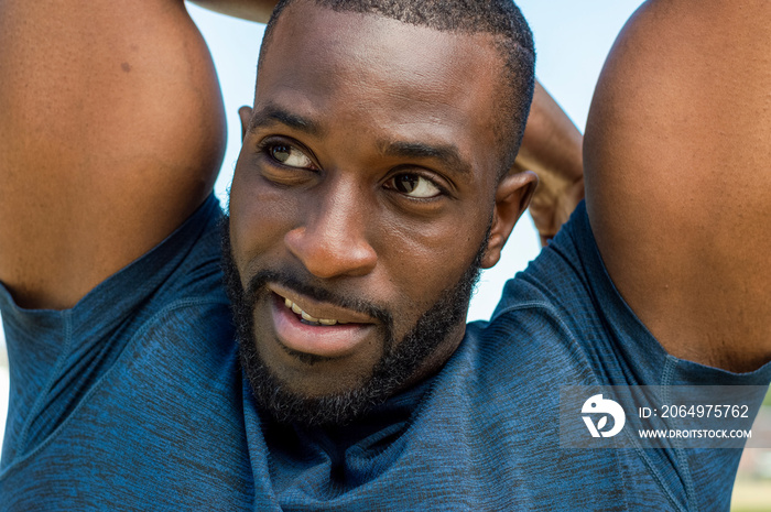 Portrait of mid adult man stretching