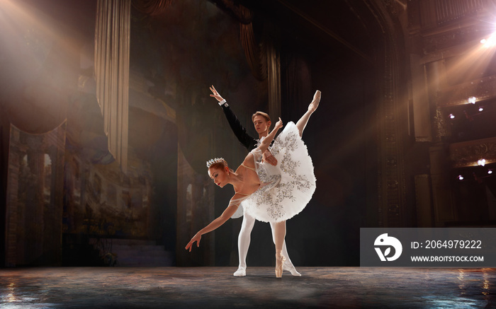 Ballet. Classical ballet performed by a couple of ballet dancers on the stage of the opera house.