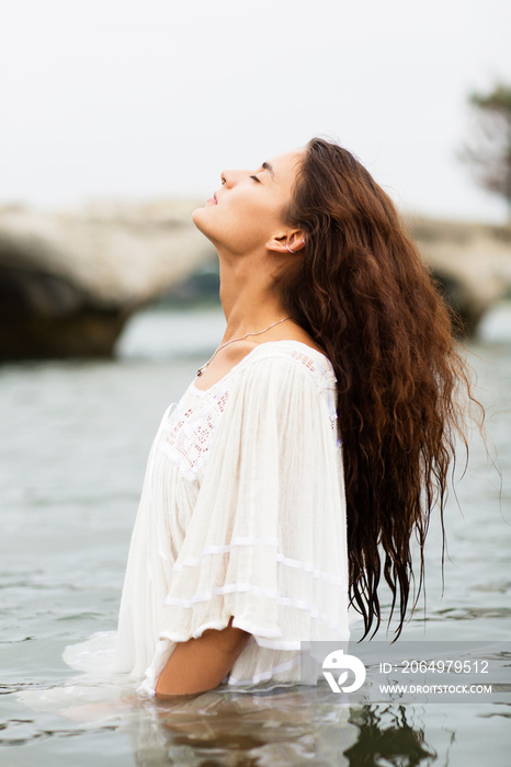 Side-view of woman in white dress