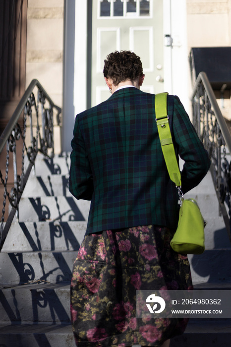 non-binary caucasian person with short brown hair going home