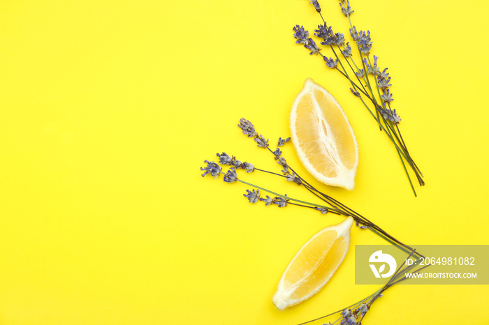 Beautiful lavender flowers with lemon pieces on color background