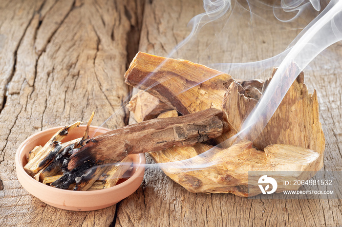 Sacred wood  palo santo  - Bursera graveolens,on rustic wood background