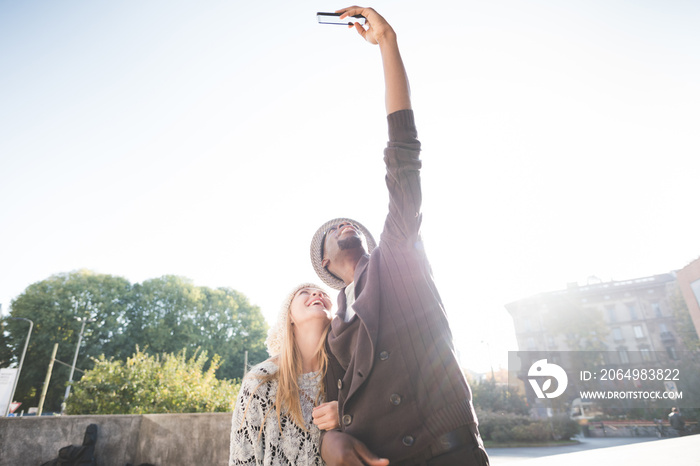 Couple taking selfie with smartphone in park